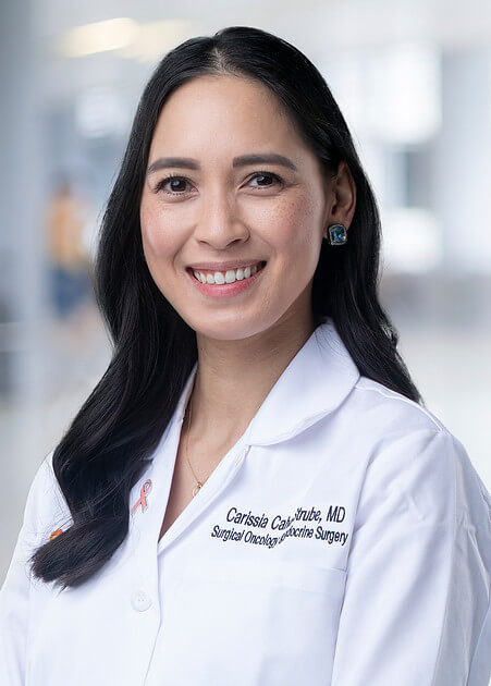 Carissia Calvo-Strube, MD, FACS, in her white coat.