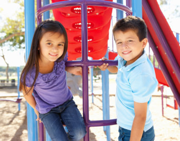 Latino kids playing in playground