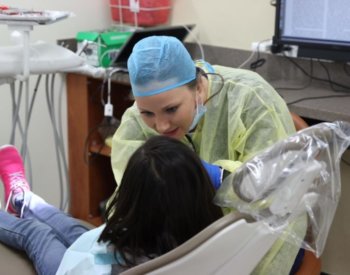 Dental student providing free care to Edgewood ISD student.
