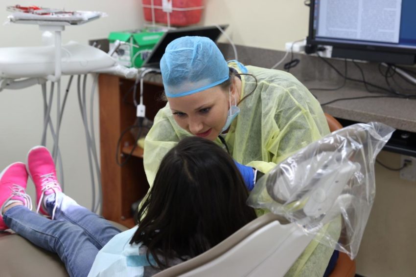 Dental student providing free care to Edgewood ISD student.