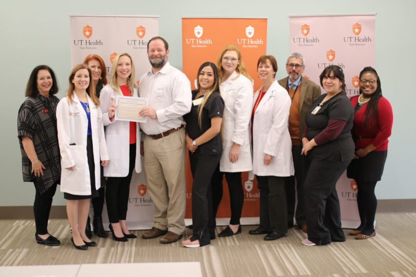 School of Nursing faculty and staff associated with Wellness 360 receive the Foster Care Center of Excellence designation from Superior HealthPlan's Todd Nicholas.