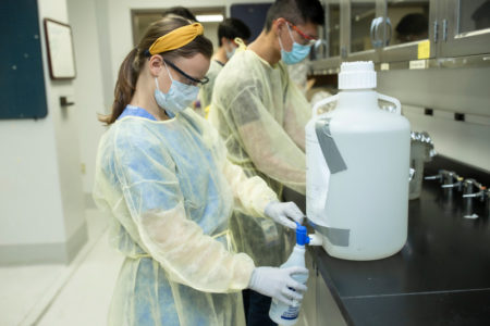 Medical student dispenses hand sanitizer