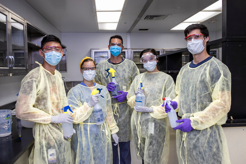 Medical students and bottles of hand sanitizer