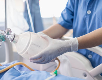 Doctor holding oxygen over patients in ICU/Emergency Room