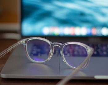 eyeglasses on top of laptop