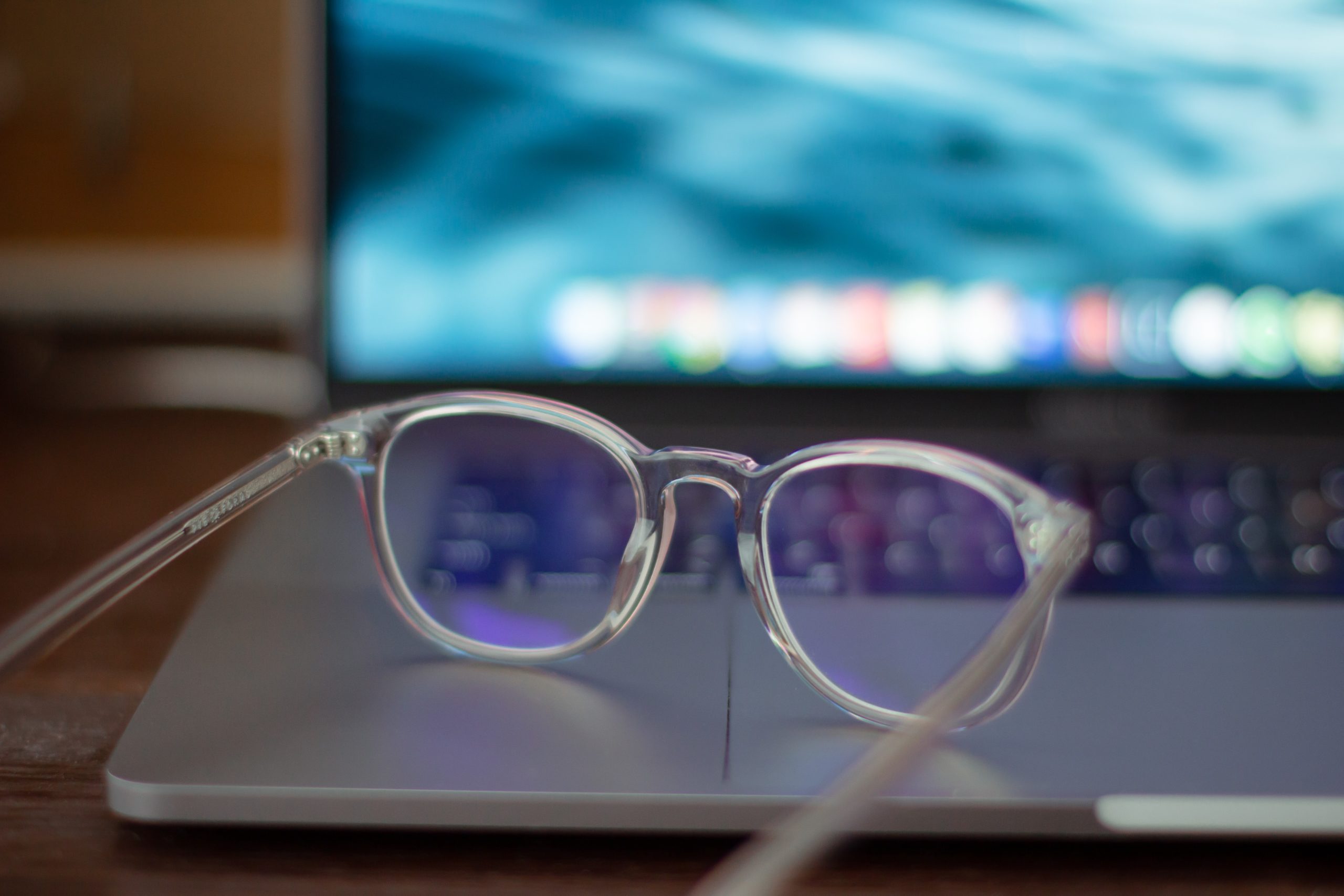 eyeglasses on top of laptop