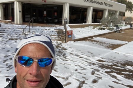Michael Geelhoed, DPT, OCS, MTC, assistant professor and director of clinical education in the Department of Physical Therapy, stands in the snow on campus.