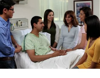 Photo of Latino family in hospital room.