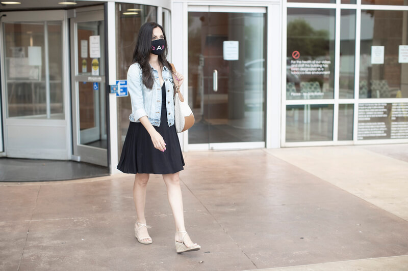 woman walks at UT Health San Antonio wearing a mask.