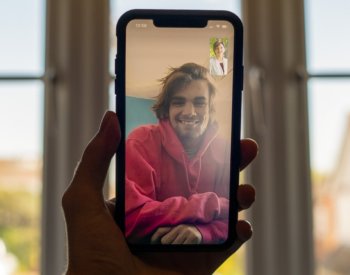 Photo of young man holding cell phone