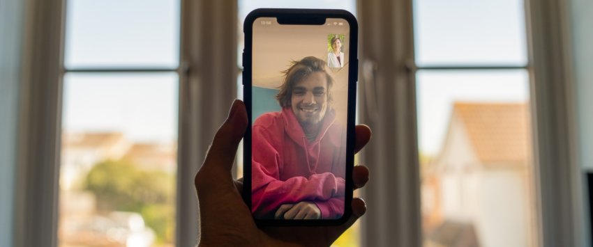 Photo of young man holding cell phone