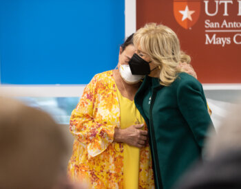 Jill Biden embraces patient Rainee Miller.