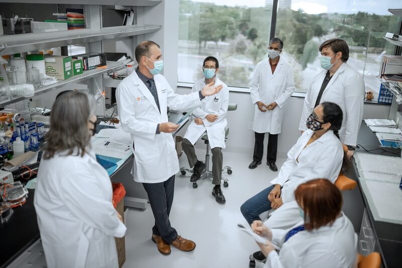 Photo of Dr. Robert Hromas with a lab team