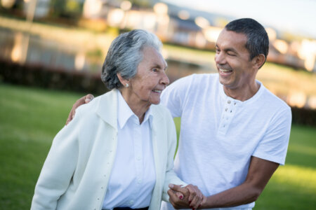 Photo of senior adult with her caregiver-son