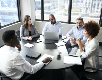 Elevated view of corporate business colleagues talking in a meeting room