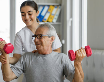 Nurse and male patient exercising