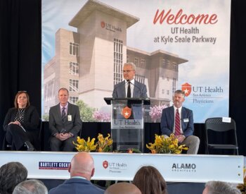 Robert Leverence, MD, stands at a podium at UT Health at Kyle Seale Parkway.