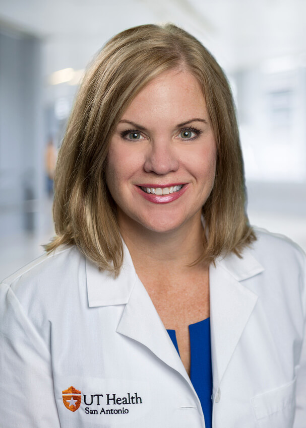 Head shot of Dr. Lisa Cleveland smiling in her UT Health San Antonio-banded white coat.