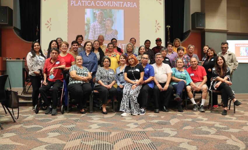 A group of community members gather for a photo at a past plática.