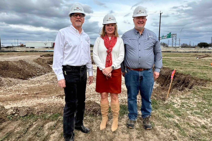 Leaders of this construction project stand side by side in front of the campus groundbreaking.