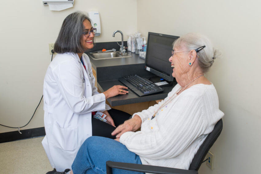 Neela K. Patel, MD, in an office visit. During the pandemic, promotores helped the geriatrics and supportive care team to expand visits to homebound patients and reduce ER visits.