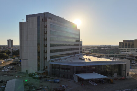 UT Health Multispecialty and Research Hospital with sun behind it.