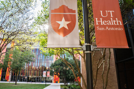 Outside shot of UT Health San Antonio banners in the courtyard of the Joe R. and Teresa Lozano Long Campus.