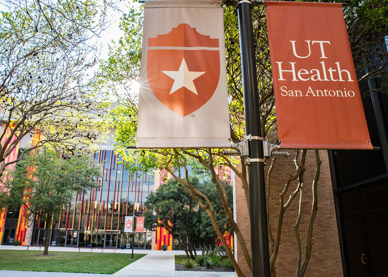 Outside shot of UT Health San Antonio banners in the courtyard of the Joe R. and Teresa Lozano Long Campus.