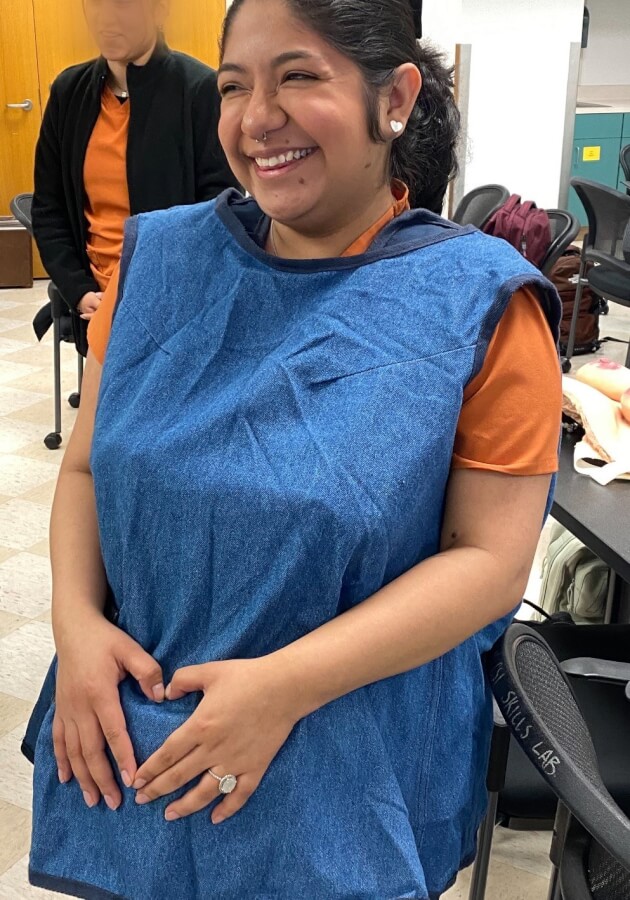 School of Nursing student Dayelsy Navarrete Alvarez dons a pregnancy belly for a simulation exercise