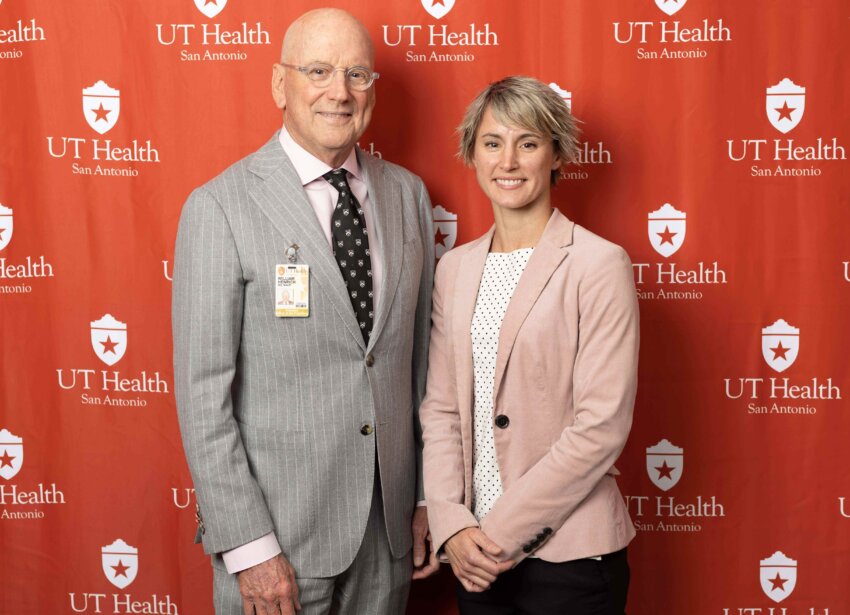 Gina Baxter, 2024 graduate of the Master of Science in Speech-Language Pathology program, poses with former UT Health San Antonio President William L. Henrich, MD, MACP