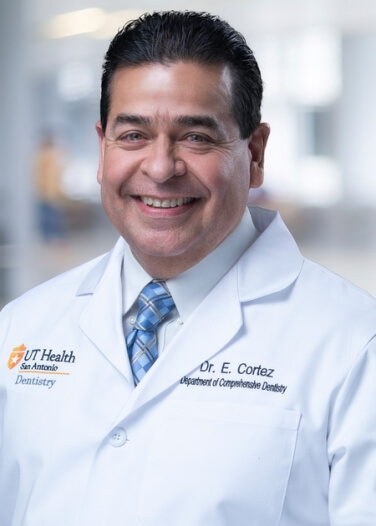 Dr. Eddie Cortez in his white coat smiles.