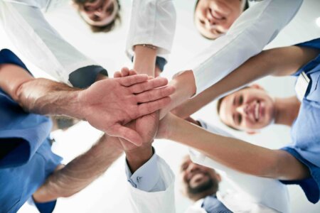 group of health care workers in a team huddle