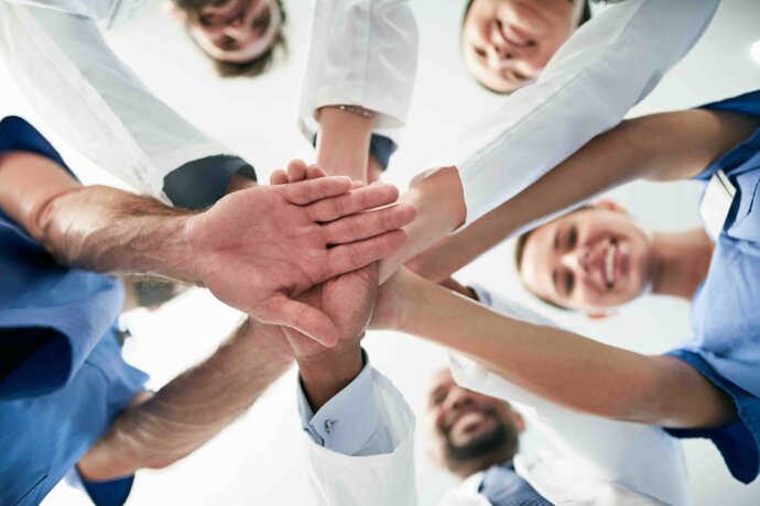 group of health care workers in a team huddle