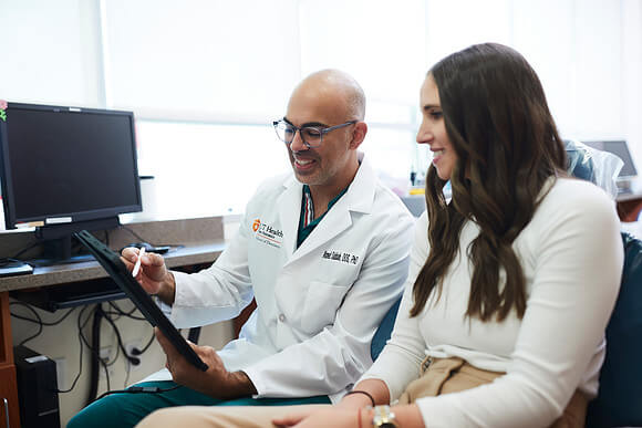 Dr. Sabbah and his patient look at the proposed treatment plan together.