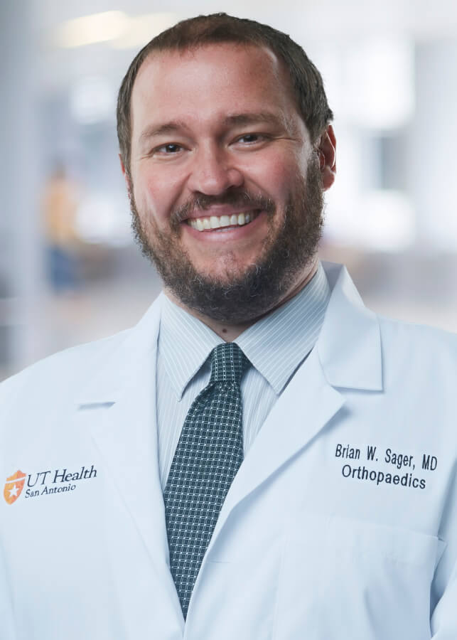 A professional head and shoulders photo of Dr. Brian Sager in his white coat.