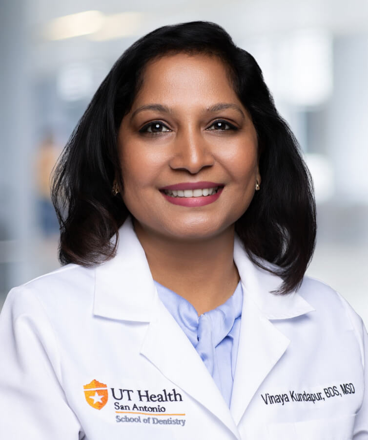 A professional head and shoulders photo of Vinaya Kundapur in her clinical white coat.