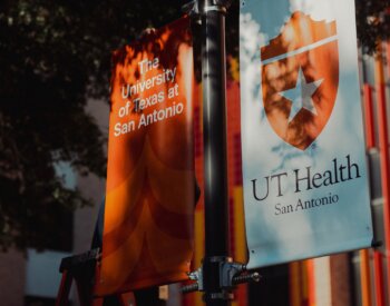 A closeup of the university flag banners located outside of the courtyard.