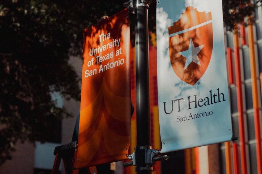 A closeup of the university flag banners located outside of the courtyard.