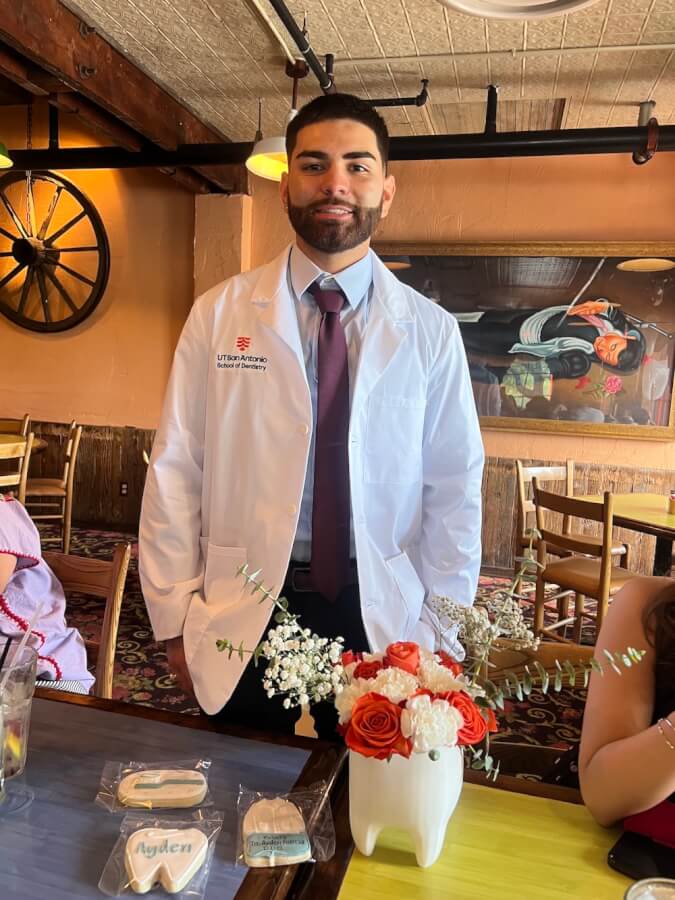 Ayden Garcia proudly wears his white coat after the School of Dentistry's White Coat Ceremony.