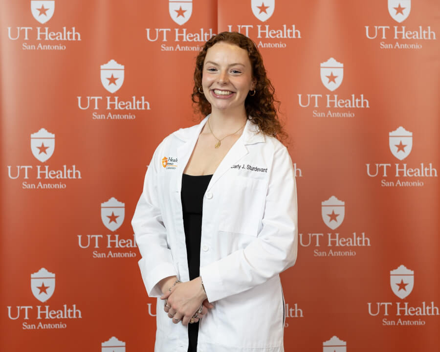 Master’s student Carly Sturdevant, president of the Medical Laboratory Sciences class of 2027, proudly wears her white coat following the White Coat Ceremony.