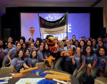 Students from the School of Nursing's nurse anesthesia program pose with UTSA mascot, Rowdy, at the TXANA College Bowl.