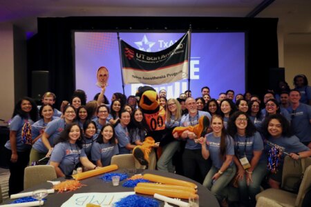Students from the School of Nursing's nurse anesthesia program pose with UTSA mascot, Rowdy, at the TXANA College Bowl.