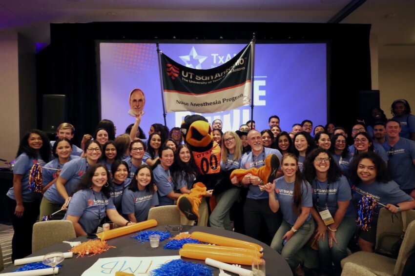 Students from the School of Nursing's nurse anesthesia program pose with UTSA mascot, Rowdy, at the TXANA College Bowl.