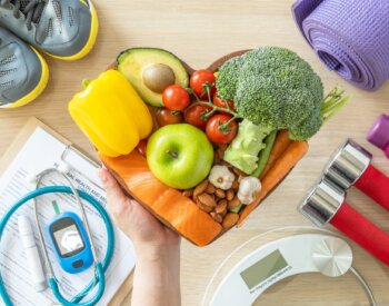 Conceptual image depicting Healthy lifestyle on ketogenic diet, eating clean keto food good health dietary in heart dish with aerobic body exercise, gym workout training class , weight scale and sports shoes in fitness center.