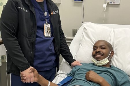 Tony Hsu, left, supervisor of apheresis and cellular therapy services at UT Health San Antonio’s Mays Cancer Center and UT San Antonio Multispecialty and Research Hospital, stands next to multiple myeloma patient Joseph Hall during the apheresis process in which blood -forming stem cells are collected, while the remaining blood is returned to the patient. Later, after the patient completes chemotherapy, the stored cells are infused back into the bloodstream. The cells travel to the bone marrow and begin producing new blood cells, helping blood counts recover over time