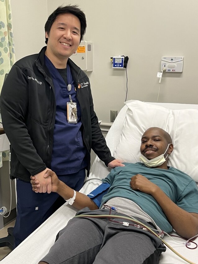 Tony Hsu, left, supervisor of apheresis and cellular therapy services at UT Health San Antonio’s Mays Cancer Center and UT San Antonio Multispecialty and Research Hospital, stands next to multiple myeloma patient Joseph Hall during the apheresis process in which blood -forming stem cells are collected, while the remaining blood is returned to the patient. Later, after the patient completes chemotherapy, the stored cells are infused back into the bloodstream. The cells travel to the bone marrow and begin producing new blood cells, helping blood counts recover over time
