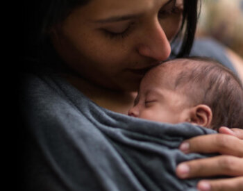 Mother holding baby.