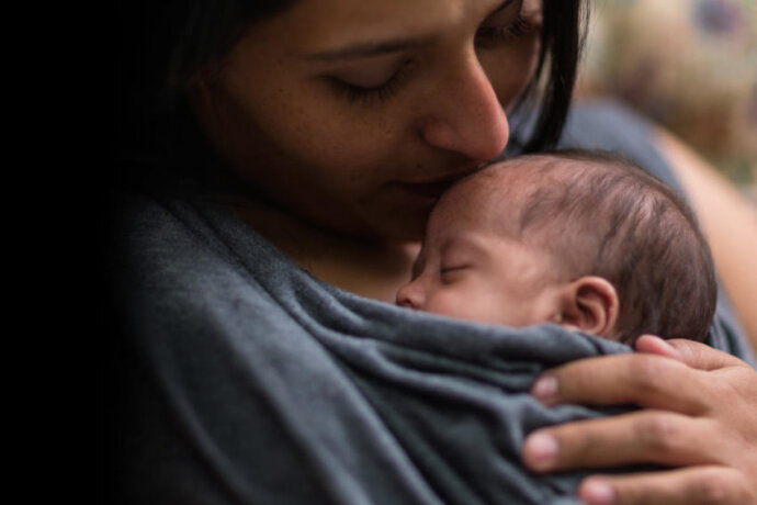 Mother holding baby.