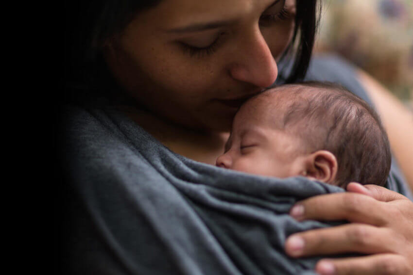 Mother holding baby.